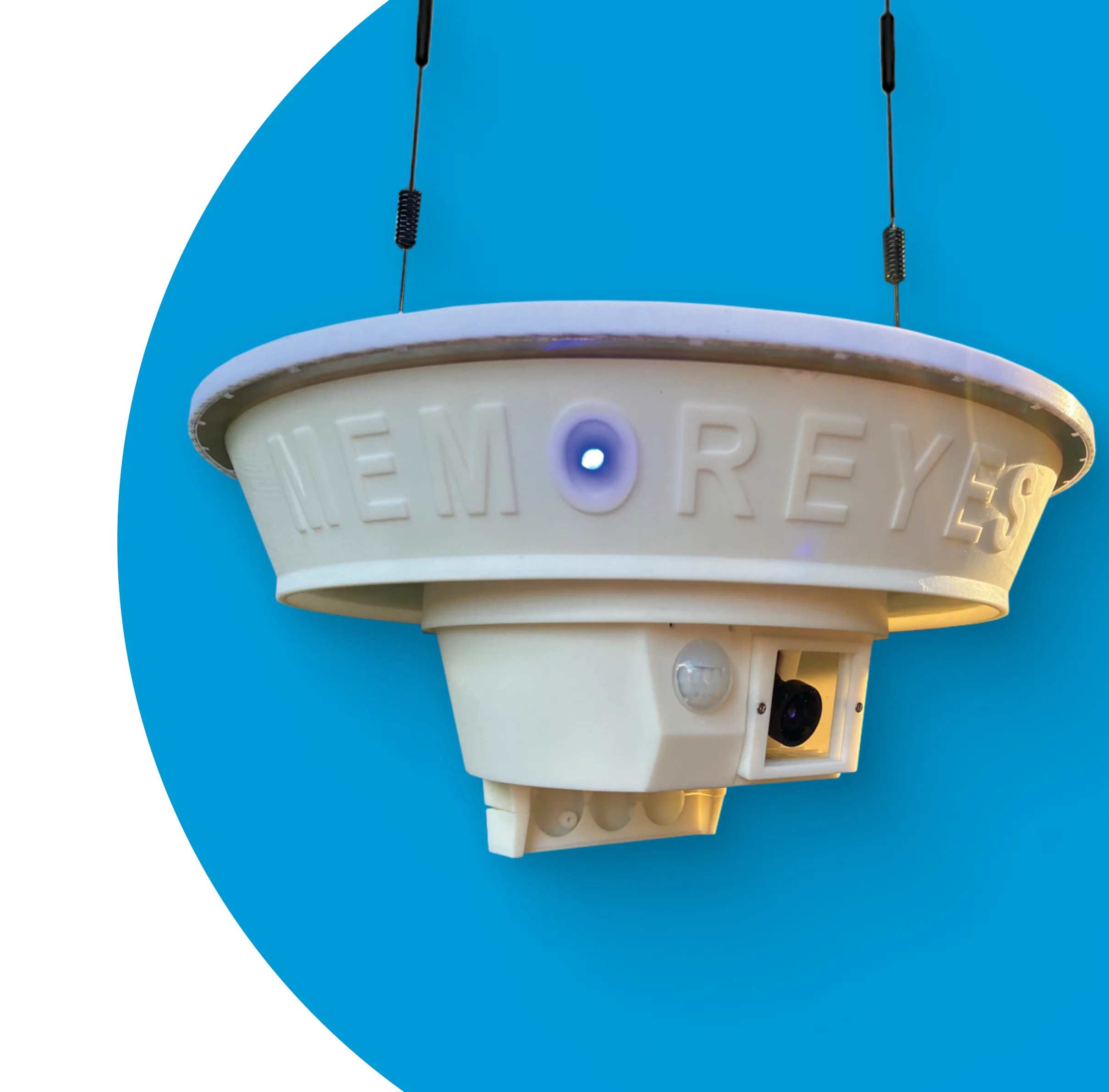 A white, circular device with a blue light and the words 'Memoreyes Municipal' embossed on it, suspended from a black cord