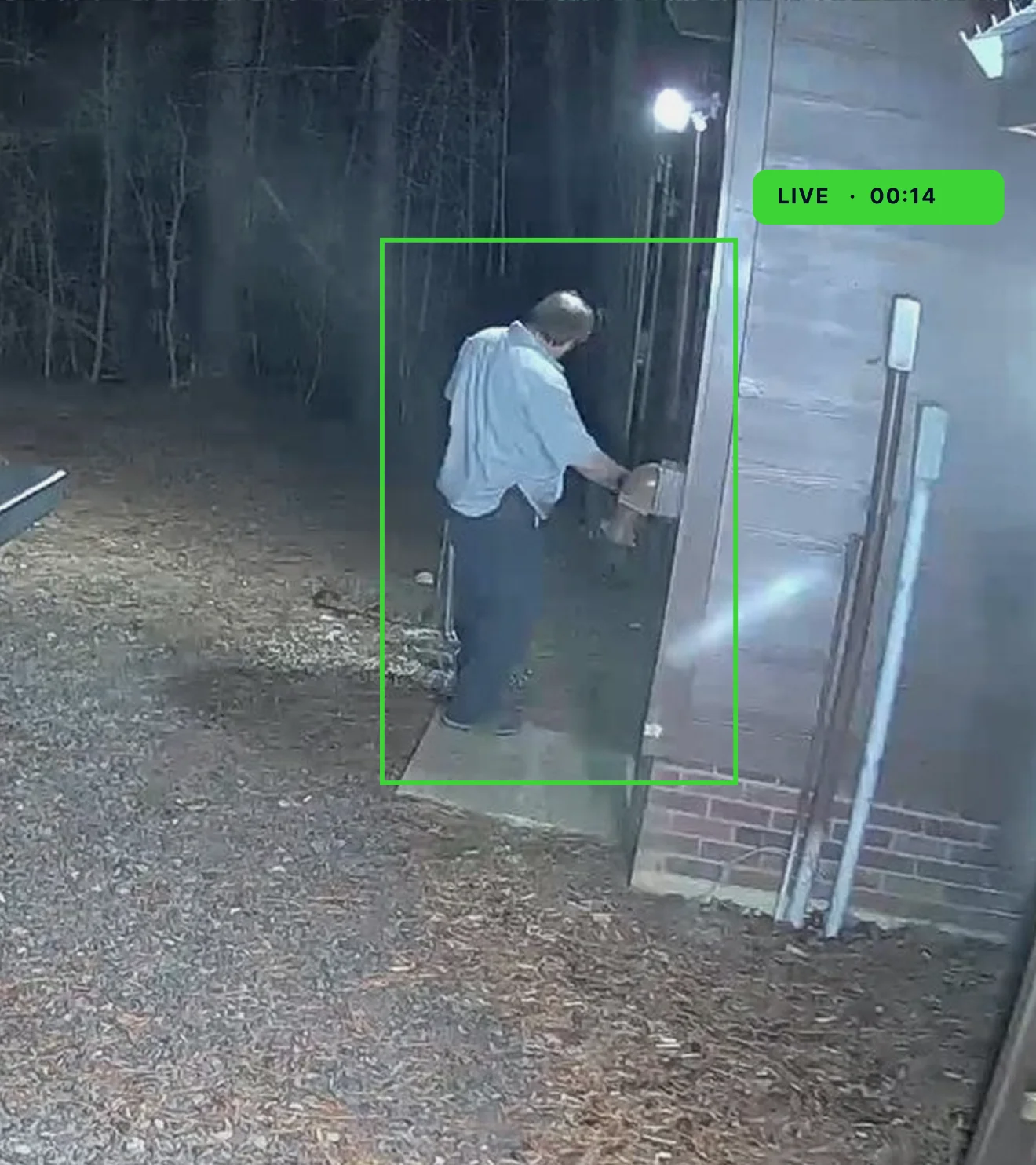 Memoreyes Municipal A man in a white shirt and dark pants is seen opening a door in a dimly lit area, with a live feed label