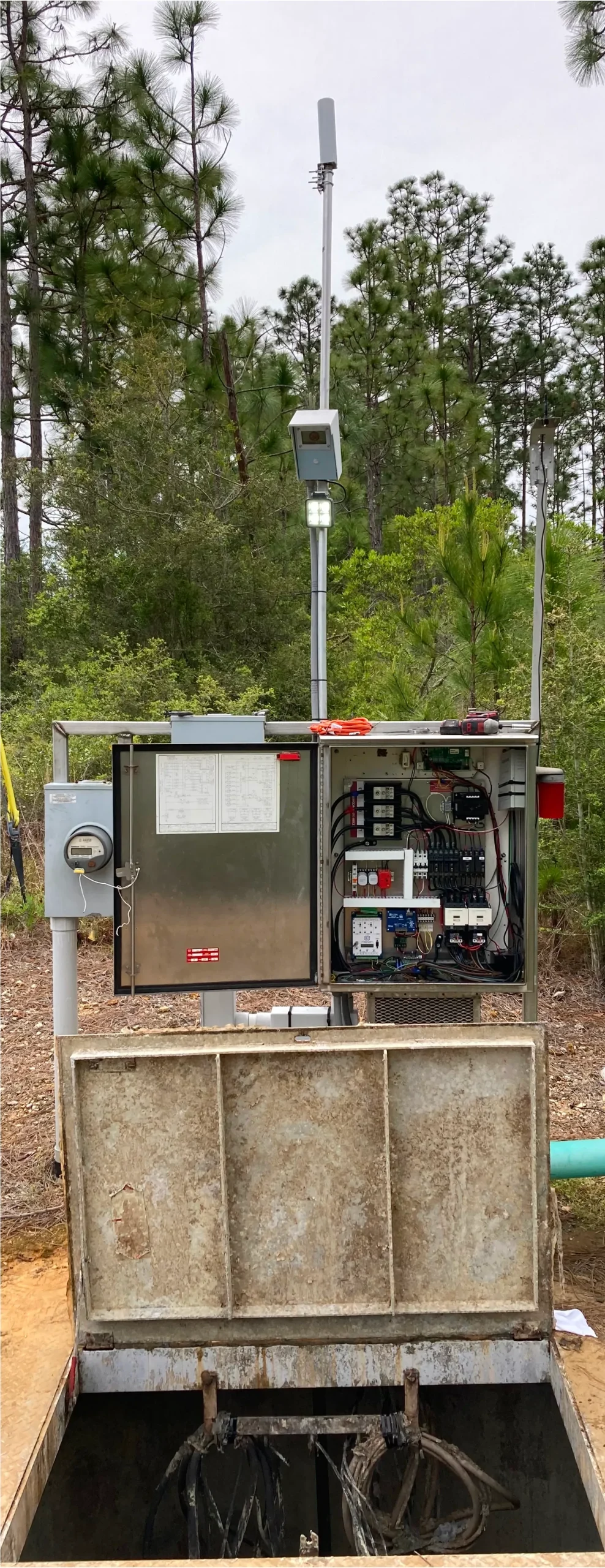 Remote lift station control panel on a pole mount in a wooded site
