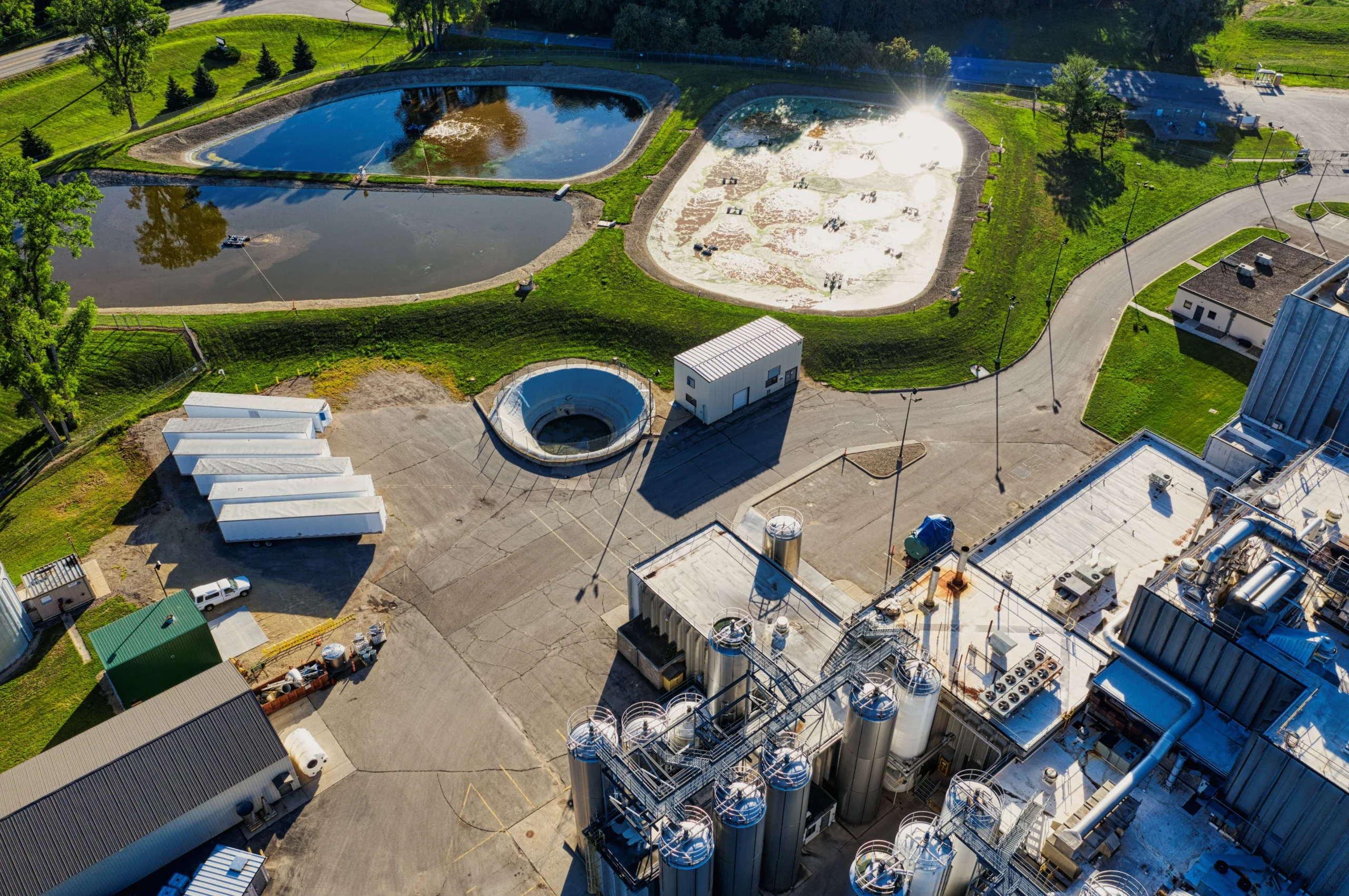 Aerial view of a wastewater treatment site with lagoons, drying beds and storage silos